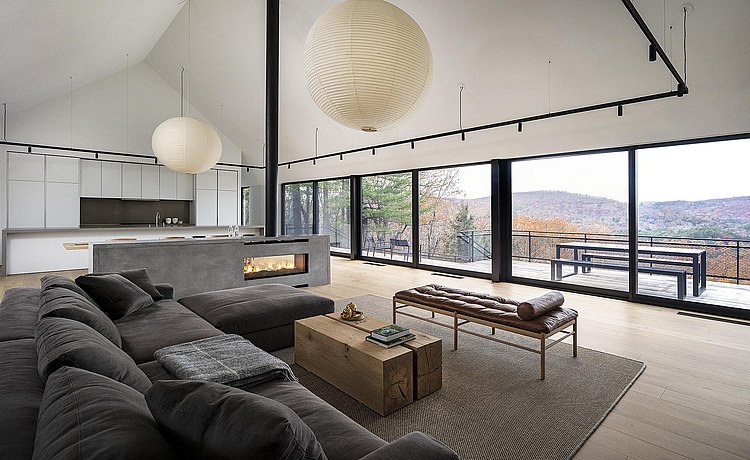 Living room area with landscape view through large windows. 